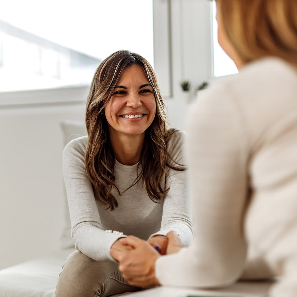 Smiling person in an individual counseling session with a therapist at QuickSilver Counseling Center