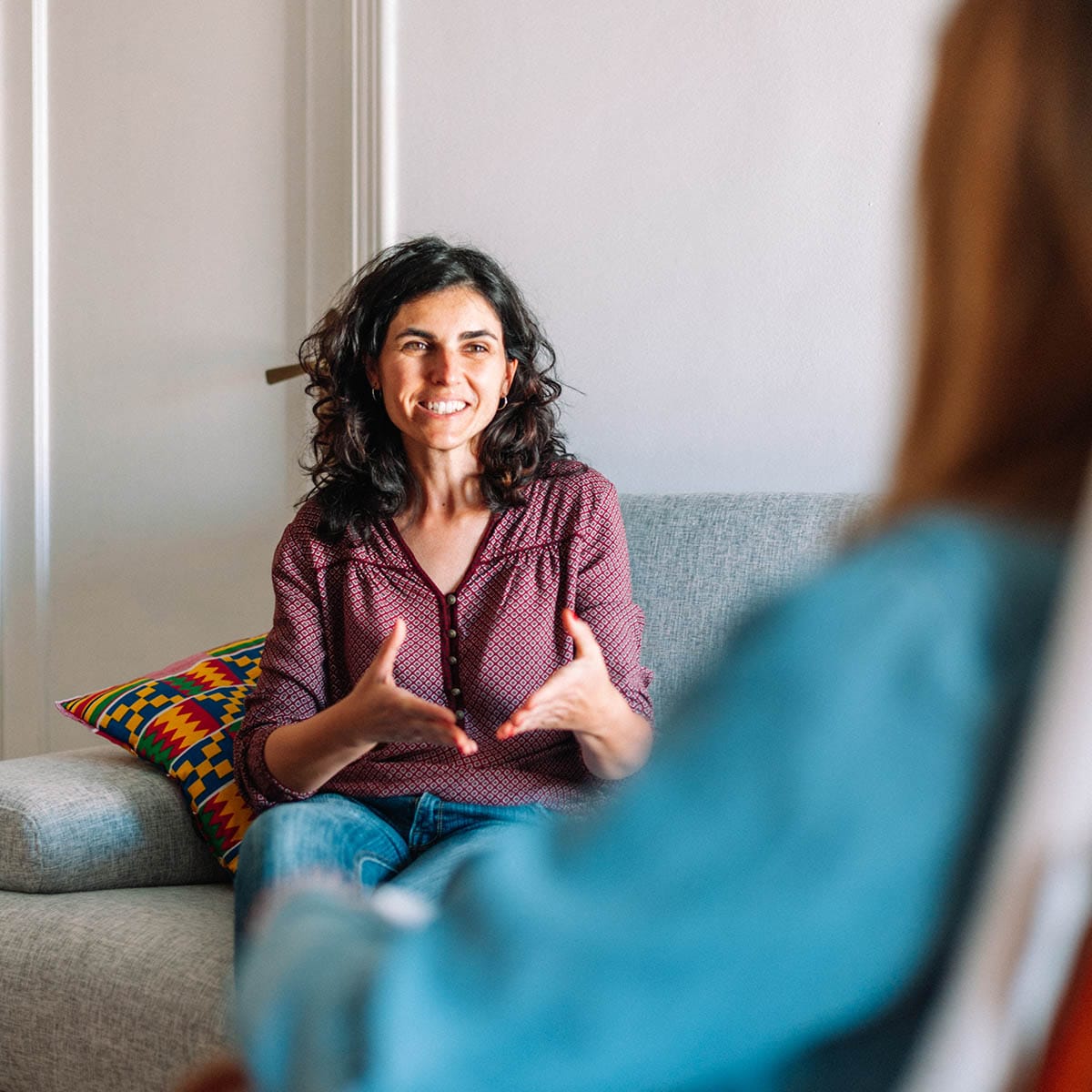 Happy person talking to a therapist at QuickSilver Counseling Center