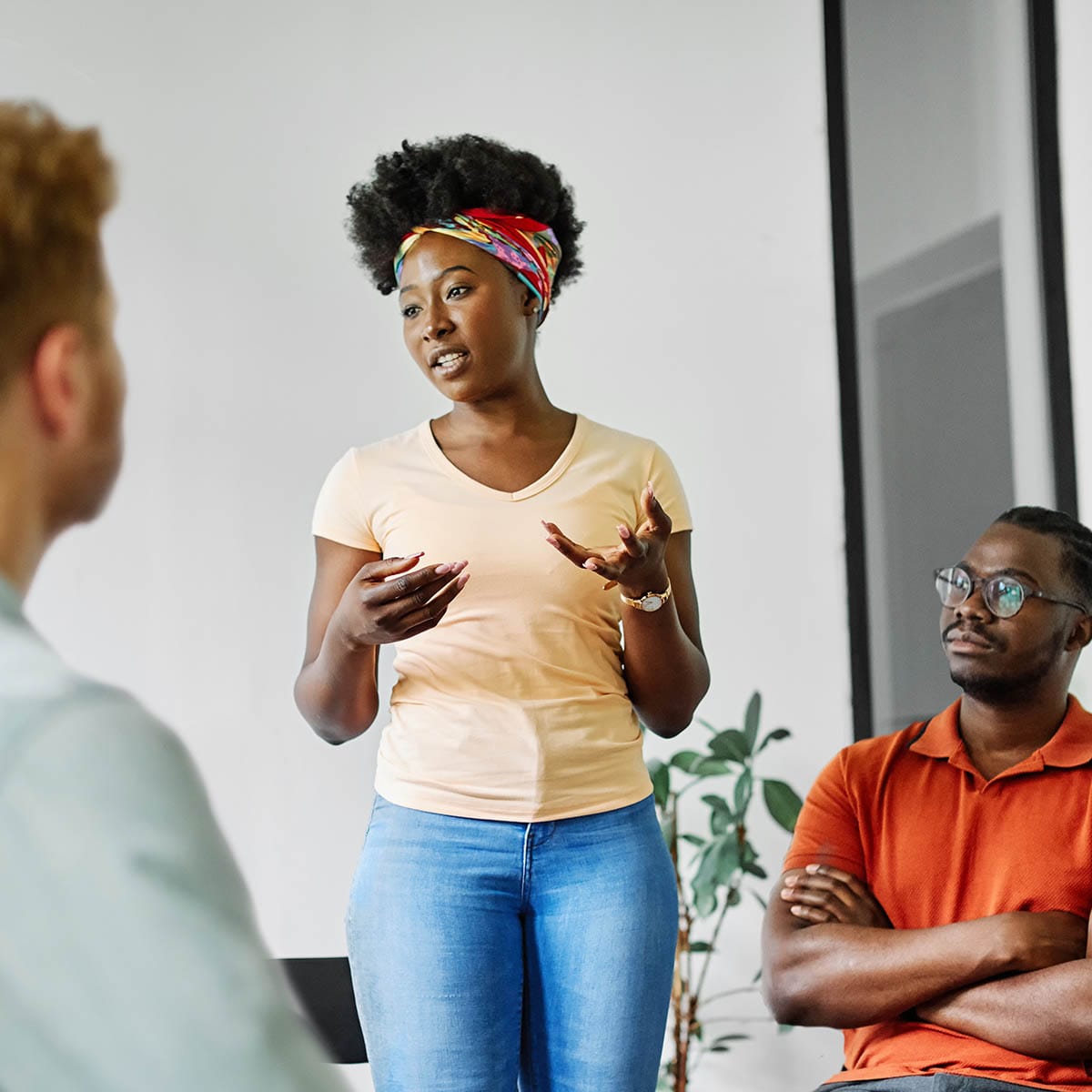 Person speaking in front of a group while participating in addiction therapy at QuickSilver Counseling Center