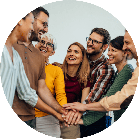 Group of happy people putting their hands together as a team