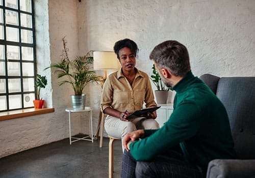 Person in session with a counselor while receiving cognitive-behavioral therapy services