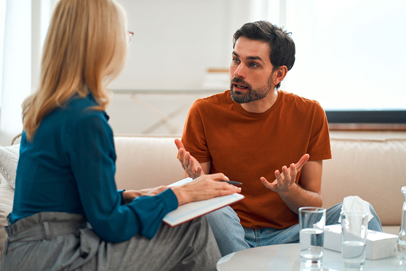 a person talks to a therapist in an Anxiety Treatment Program