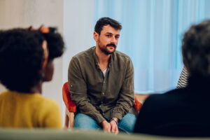 Handsome man in group therapy in a opioid addiction treatment program