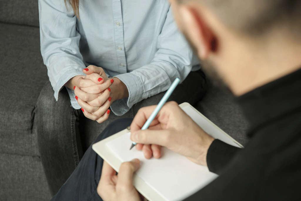 a therapist notes the benefits of dialectical-behavior therapy while a client listens