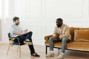 a therapist talks to a client about the benefits of Men's Rehab Program